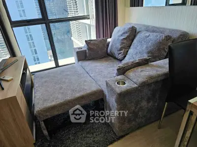 Modern living room with stylish sofa and city view through large windows