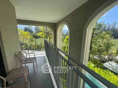 Spacious balcony with scenic garden view and elegant seating, perfect for relaxation and outdoor enjoyment.