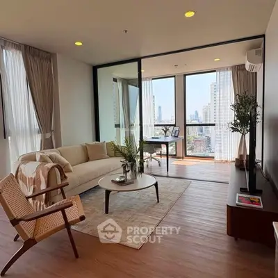 Modern living room with city view, featuring elegant furniture and floor-to-ceiling windows.