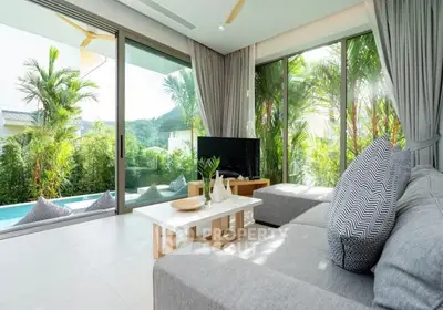 Luxurious living room with pool view and modern decor in tropical setting.