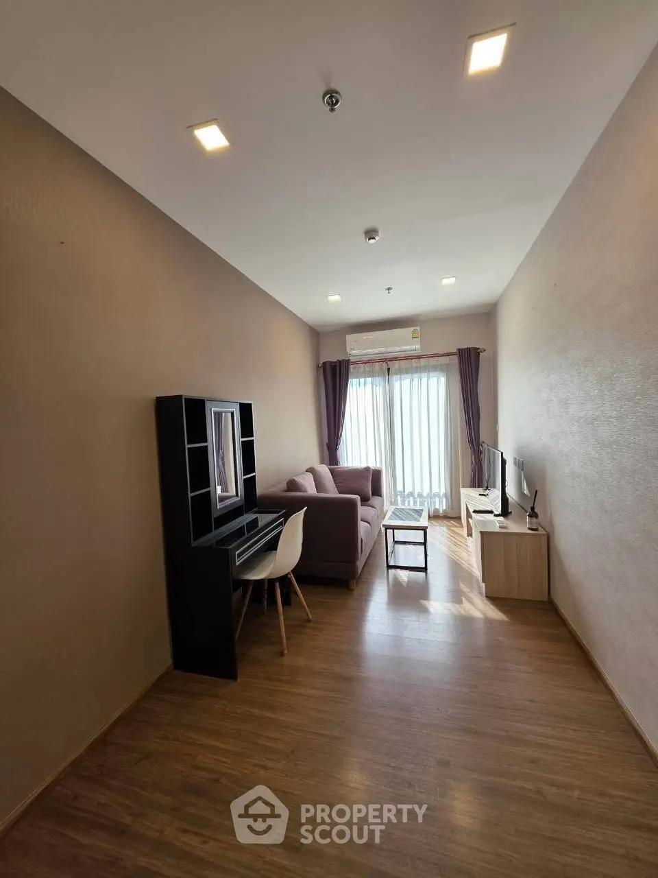 Modern living room with stylish furniture and natural light, perfect for relaxation and entertainment.