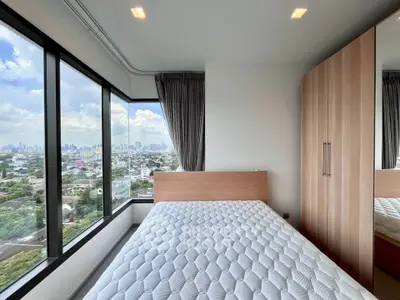 Modern bedroom with panoramic city view and sleek wardrobe