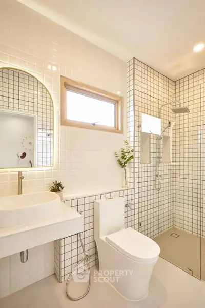 Modern bathroom with sleek white tiles and stylish fixtures