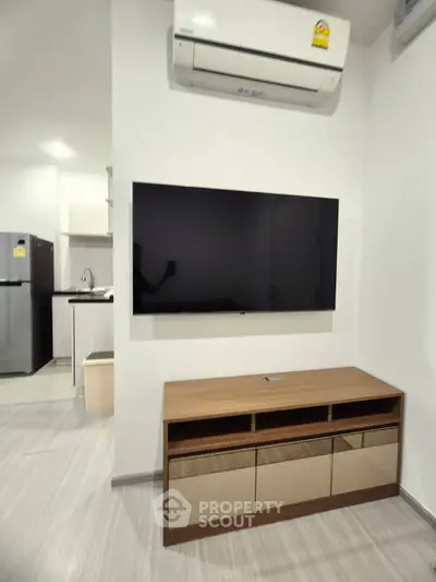 Modern living room with wall-mounted TV and sleek air conditioning unit
