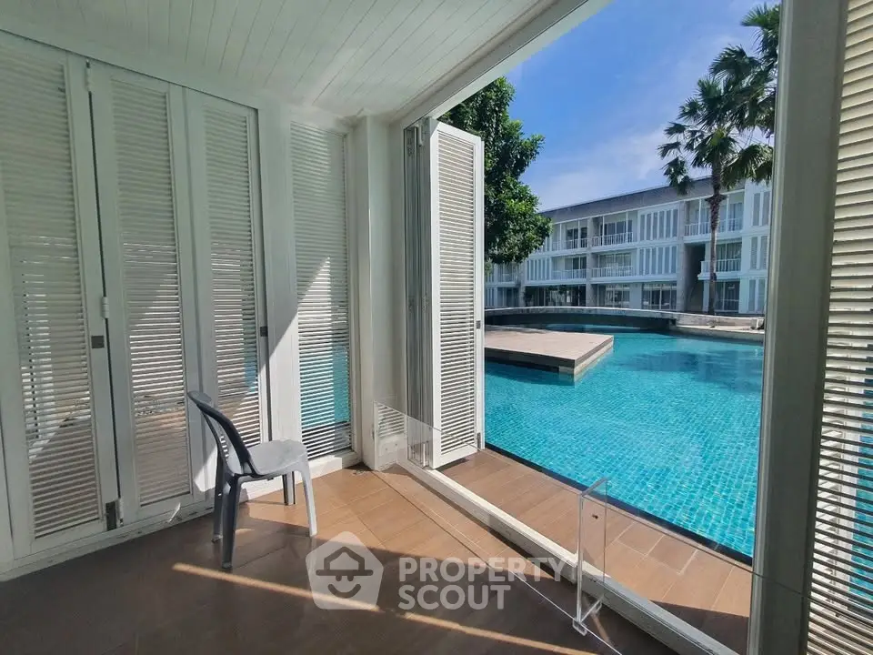 Luxurious poolside view from modern patio with open sliding doors and serene ambiance.