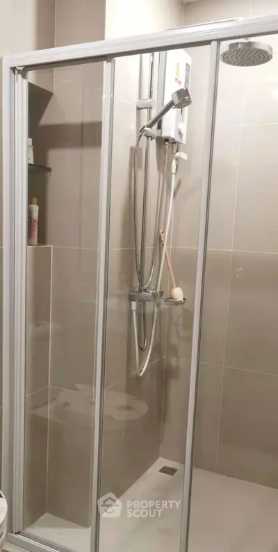 Modern bathroom with glass shower enclosure and sleek fixtures