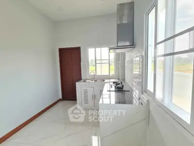 Modern kitchen with sleek countertops and gas stove in bright natural light