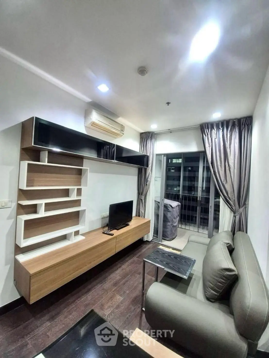 Modern living room with sleek furniture and balcony view