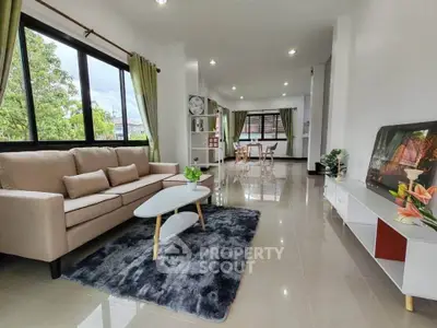 Spacious modern living room with large windows and stylish decor