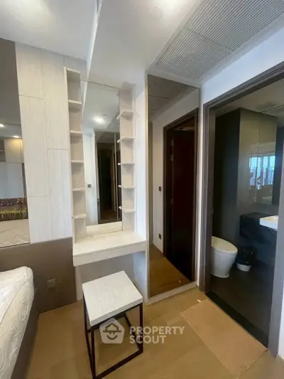 Modern bedroom with vanity and ensuite bathroom in stylish apartment