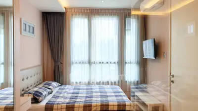 Modern bedroom with large windows and stylish decor