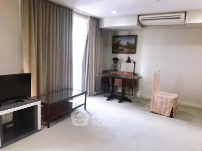 Spacious living room with elegant decor and natural light, featuring a cozy study corner and modern amenities.