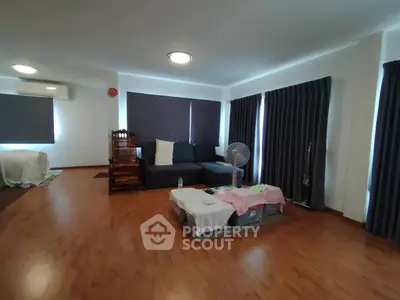 Spacious living room with modern decor and large windows for natural light.