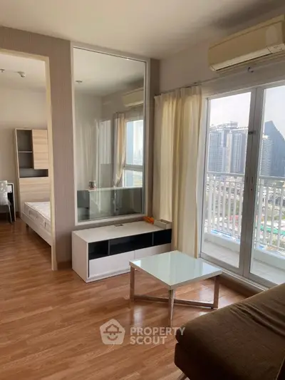 Modern apartment living room with city view and balcony access