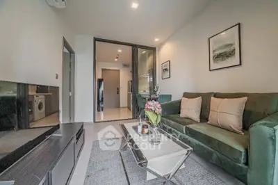 Modern living room with green sofa and stylish decor in a contemporary apartment.