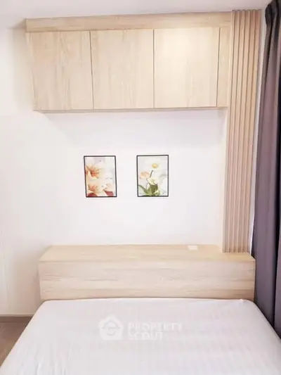 Modern bedroom with minimalist wooden furniture and floral wall art