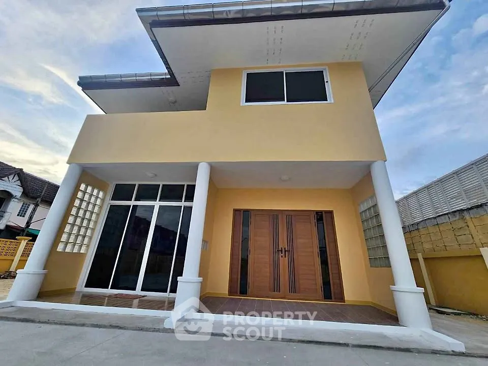 Modern two-story house with unique architectural design and spacious entrance.