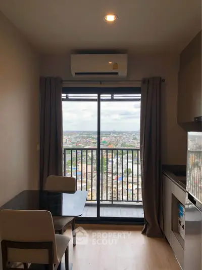 Modern apartment dining area with city view from balcony, featuring sleek furniture and air conditioning.