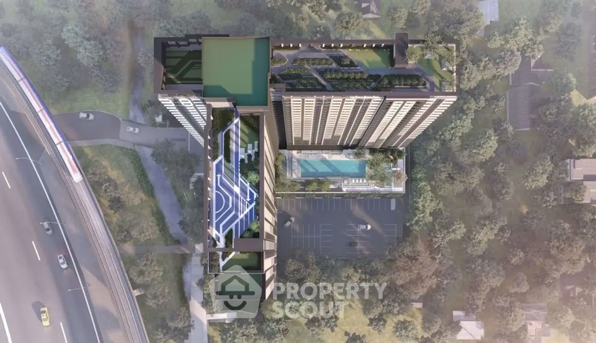 Aerial view of modern high-rise building with rooftop pool and sports court.