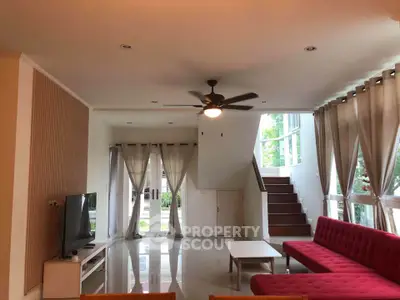 Spacious living room with modern decor and large windows for natural light.