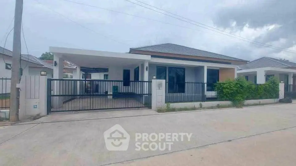 Modern single-story house with gated driveway and sleek design