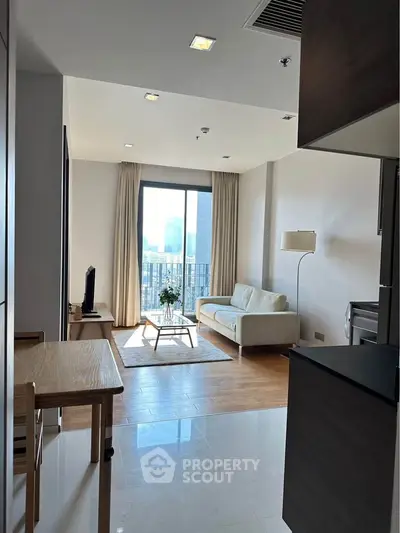 Modern living room with city view, featuring cozy sofa and natural light.
