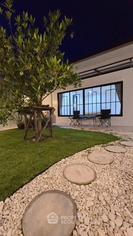 Charming garden view with modern patio seating and lush greenery, perfect for relaxation and outdoor enjoyment.