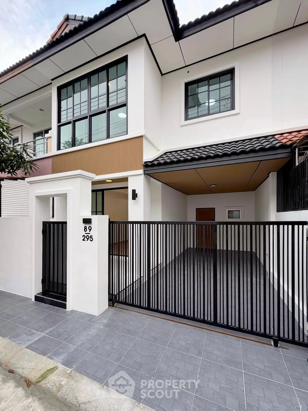 Modern two-story house with sleek design and gated entrance