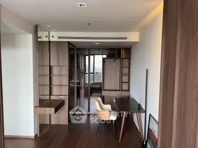 Modern study room with wooden flooring and sleek furniture in a high-rise apartment.