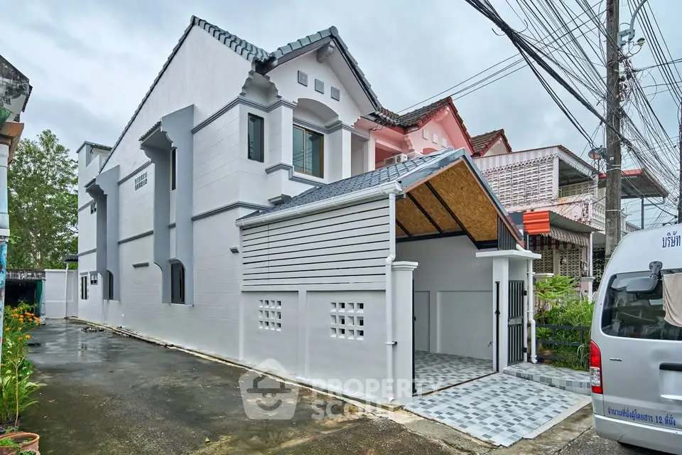 Charming two-story house with modern design and spacious driveway in a serene neighborhood.