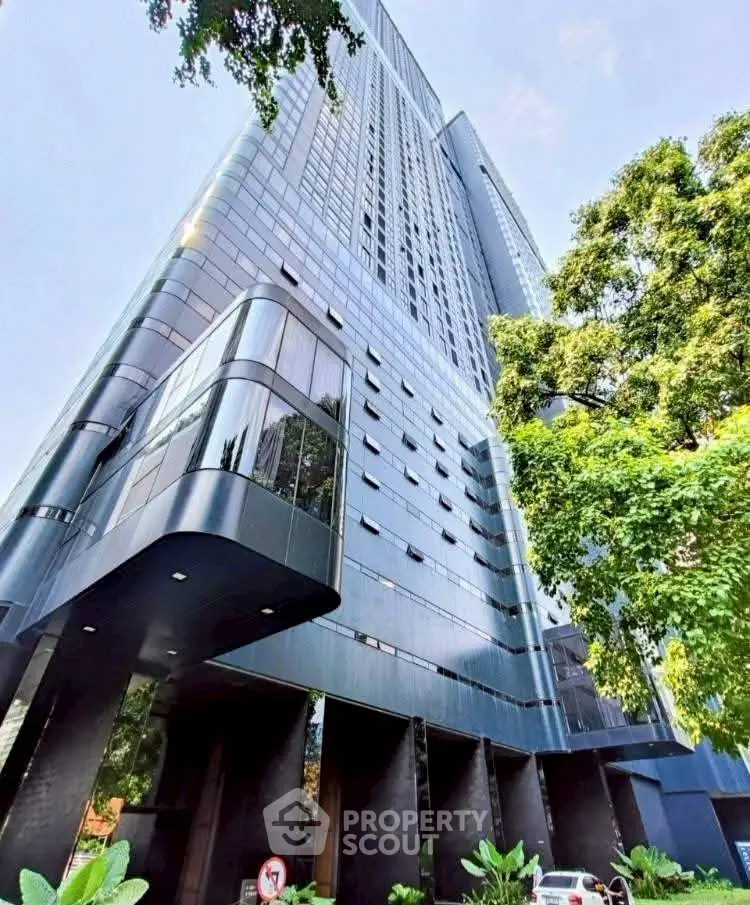 Stunning modern high-rise building with sleek architecture and lush greenery.