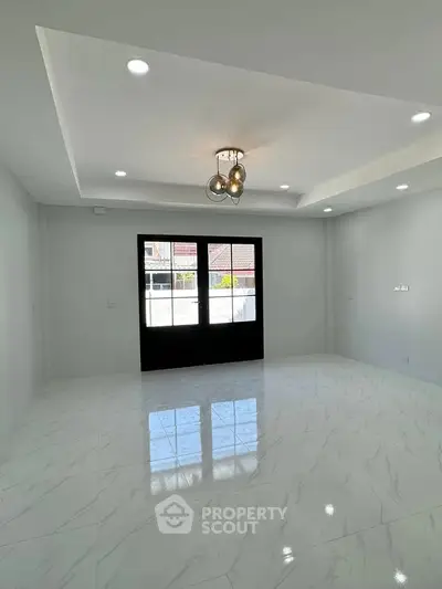 Spacious modern living room with elegant lighting and marble flooring