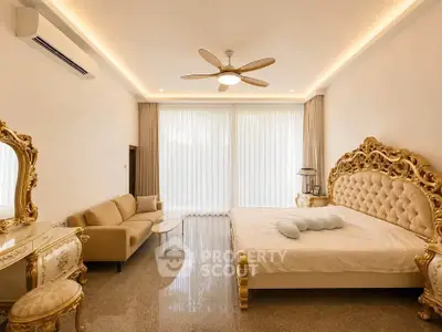 Luxurious bedroom with ornate gold furniture and elegant decor