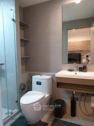 Modern bathroom with sleek fixtures and glass shower enclosure