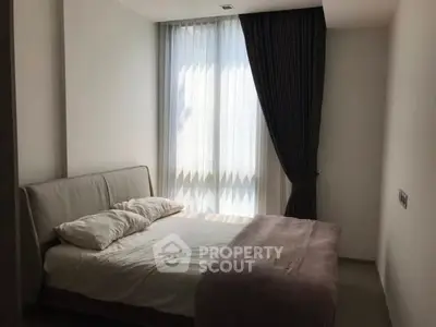 Cozy bedroom with soft lighting and elegant curtains, perfect for relaxation.