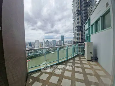 Stunning cityscape view from high-rise balcony with modern railing and river below.
