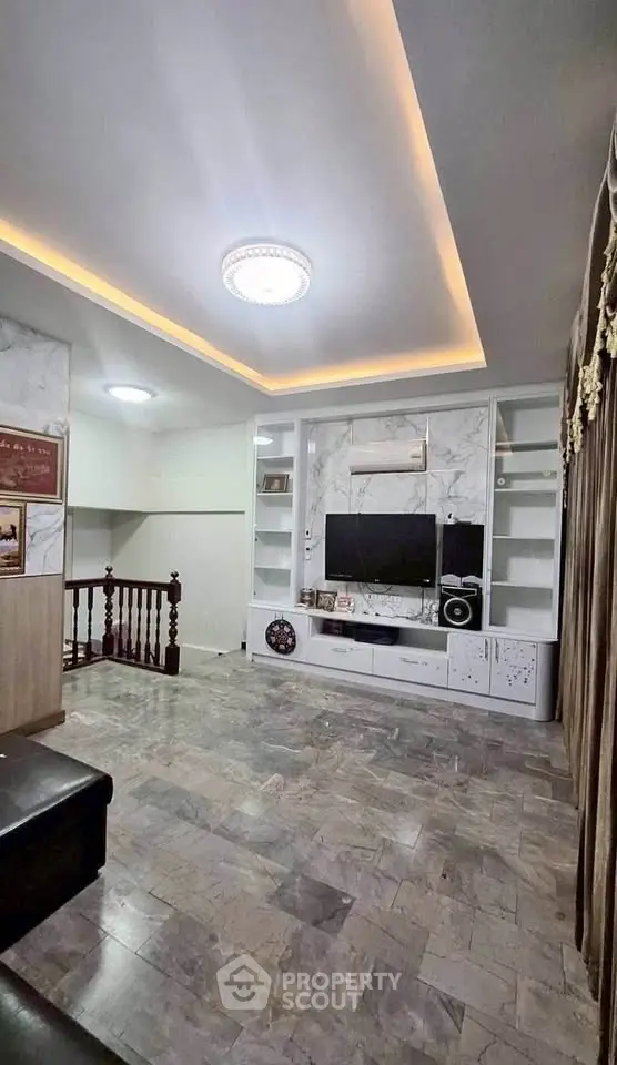 Spacious living room with modern TV unit and elegant lighting