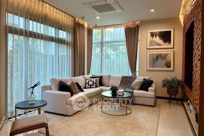 Luxurious living room with elegant decor and large windows for natural light.