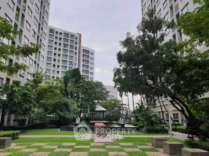Stunning garden view in modern apartment complex with lush greenery and serene atmosphere.
