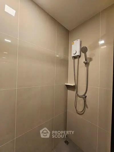 Modern bathroom with sleek shower design and neutral tiles