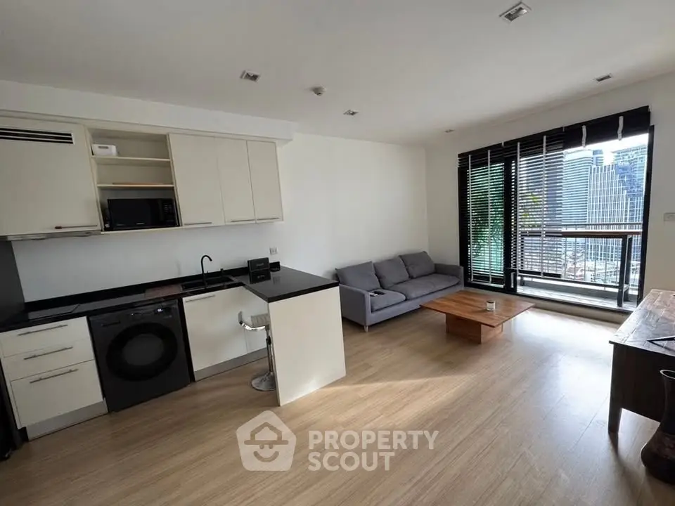 Modern open-layout living room with kitchen and city view