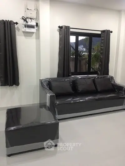 Modern living room with sleek gray sofa and matching curtains