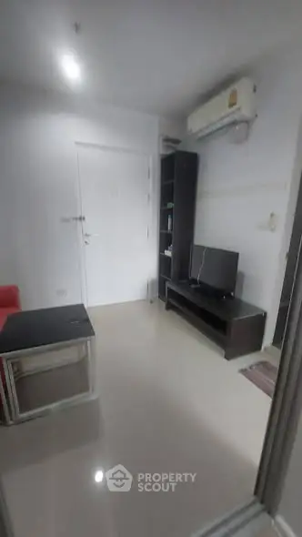 Modern living room with sleek furniture and air conditioning, perfect for urban living.