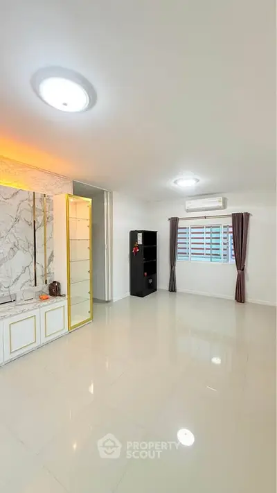 Spacious living room with modern decor and ample natural light