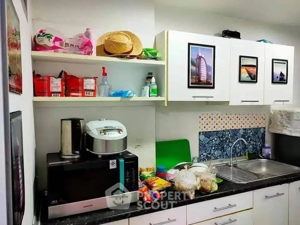 Charming kitchen with modern appliances and ample storage space, perfect for culinary enthusiasts.