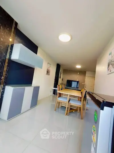 Modern dining area with sleek furniture and stylish decor in a contemporary apartment.