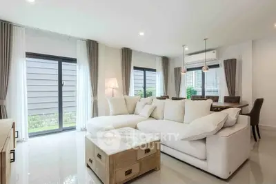 Spacious modern living room with elegant decor and large windows for natural light.
