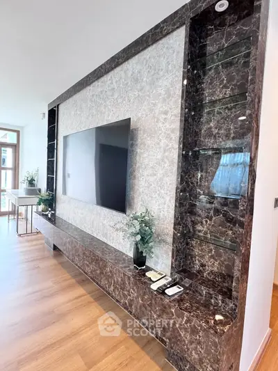 Luxurious living room with elegant marble TV wall and modern decor