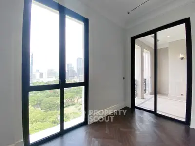 Bright room with large windows offering stunning city and park views