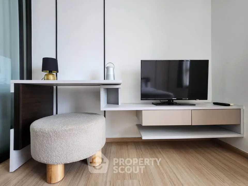 Modern living room with sleek TV stand and cozy seating, perfect for relaxation and entertainment.